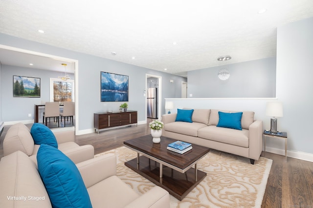 living room featuring hardwood / wood-style floors and a textured ceiling