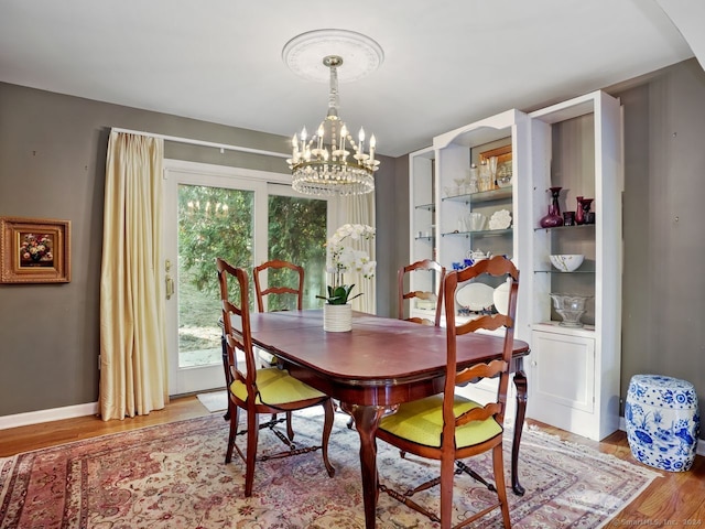 201 Shore Rd, Greenwich, CT 06830 - dining space with light wood-style floors, baseboards, and a chandelier