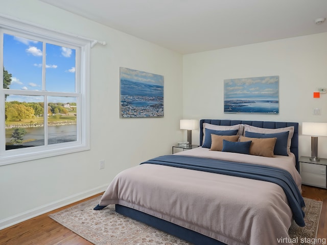 201 Shore Rd, Greenwich, CT 06830 - bedroom with a water view, baseboards, and wood finished floors