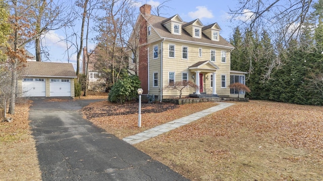 view of front of property with an outdoor structure and a garage