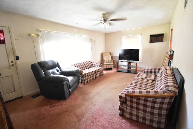 carpeted living room with ceiling fan