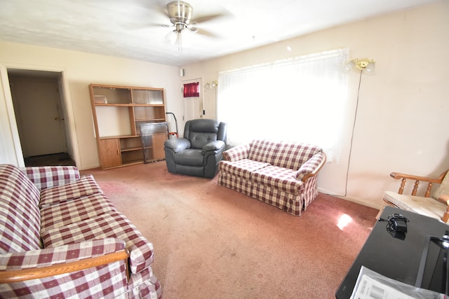 carpeted living room featuring ceiling fan