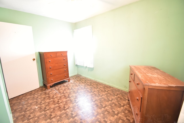 bedroom with dark parquet flooring