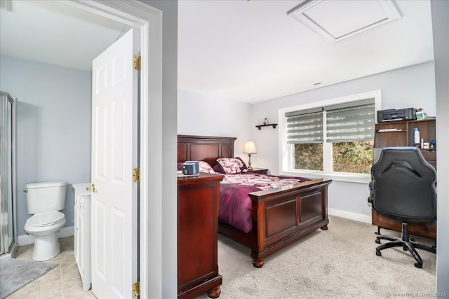 bedroom featuring light carpet and ensuite bath