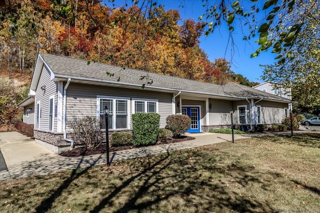 back of house with a lawn