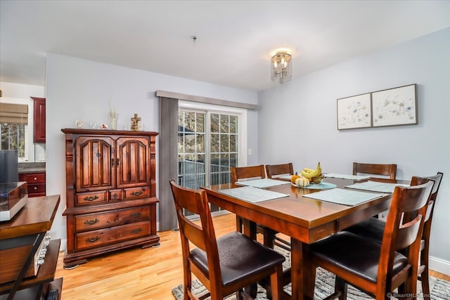 dining space with a wealth of natural light and light hardwood / wood-style floors