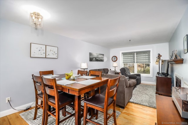 dining room featuring a chandelier and light wood-type flooring