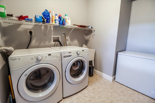 clothes washing area featuring washer and dryer