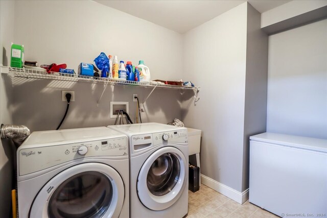 clothes washing area featuring washing machine and clothes dryer