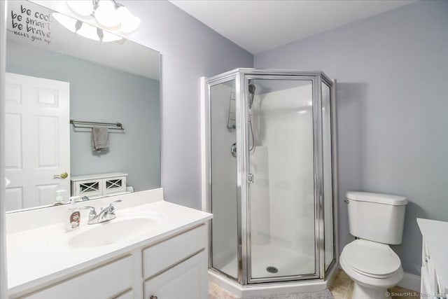 bathroom with vanity, a shower with shower door, toilet, and tile patterned flooring