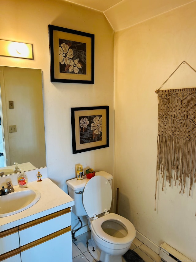 bathroom with tile patterned floors, toilet, a baseboard heating unit, vaulted ceiling, and vanity