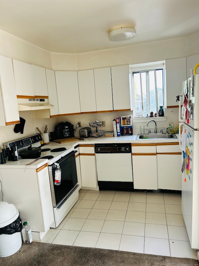 kitchen featuring washer / dryer, white cabinets, light tile patterned floors, sink, and white appliances