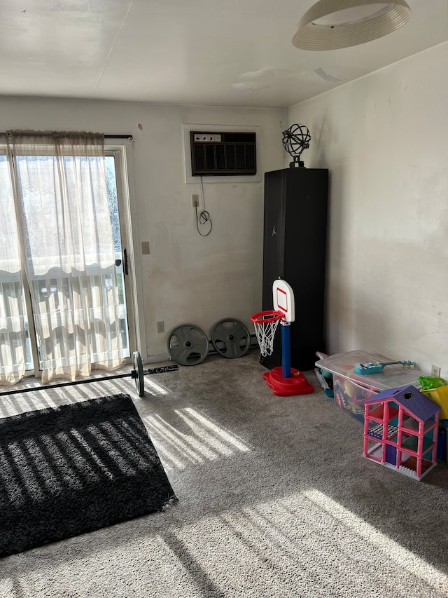 interior space with an AC wall unit and carpet flooring