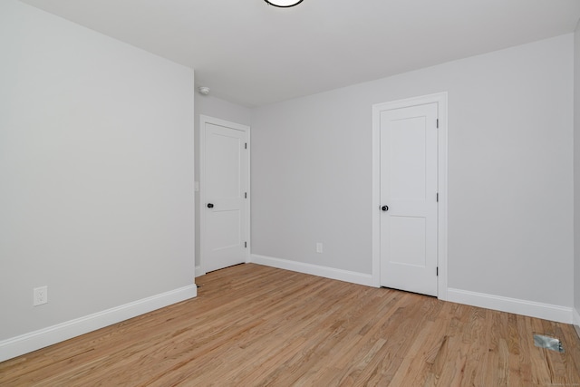 spare room featuring light wood-type flooring