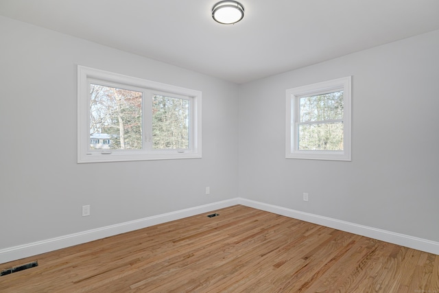 spare room featuring light wood-type flooring