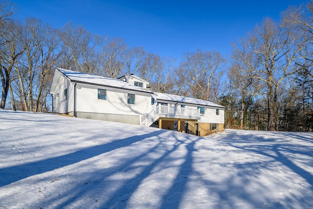 snow covered house with a deck