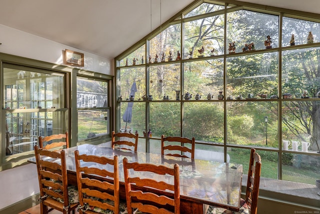 sunroom with lofted ceiling and a healthy amount of sunlight