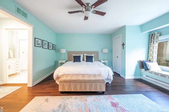 bedroom featuring ceiling fan, dark hardwood / wood-style flooring, and ensuite bath