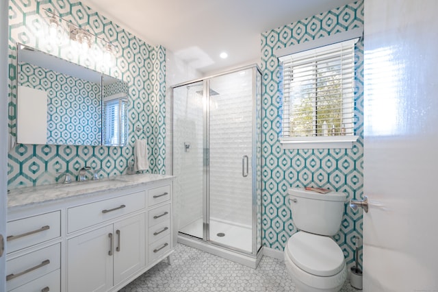 bathroom featuring vanity, toilet, walk in shower, and tile patterned flooring