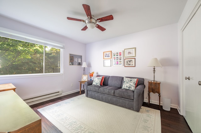 living room featuring dark hardwood / wood-style floors, a baseboard heating unit, and ceiling fan