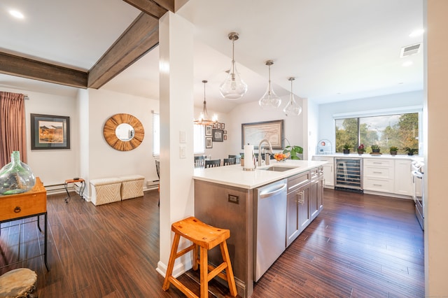 kitchen with beam ceiling, appliances with stainless steel finishes, decorative light fixtures, wine cooler, and dark hardwood / wood-style floors