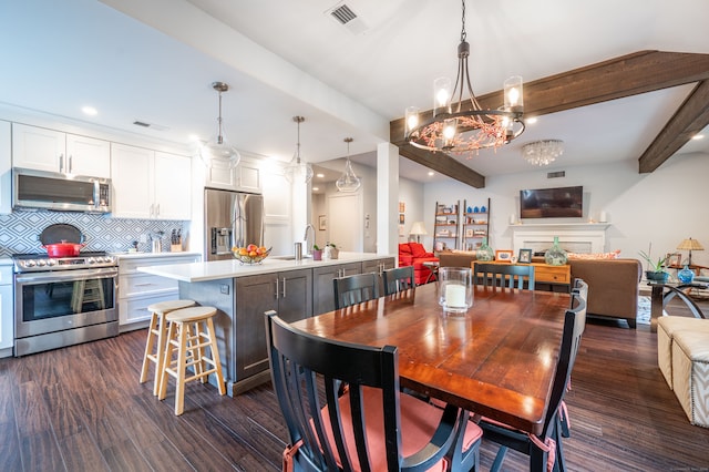 dining space with sink, beamed ceiling, dark hardwood / wood-style flooring, and an inviting chandelier