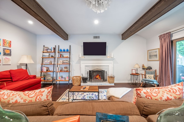 living room featuring beam ceiling, a brick fireplace, and hardwood / wood-style floors