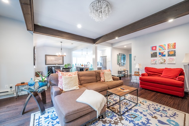 living room with a notable chandelier, dark hardwood / wood-style floors, and beam ceiling