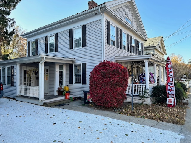 view of property exterior featuring covered porch