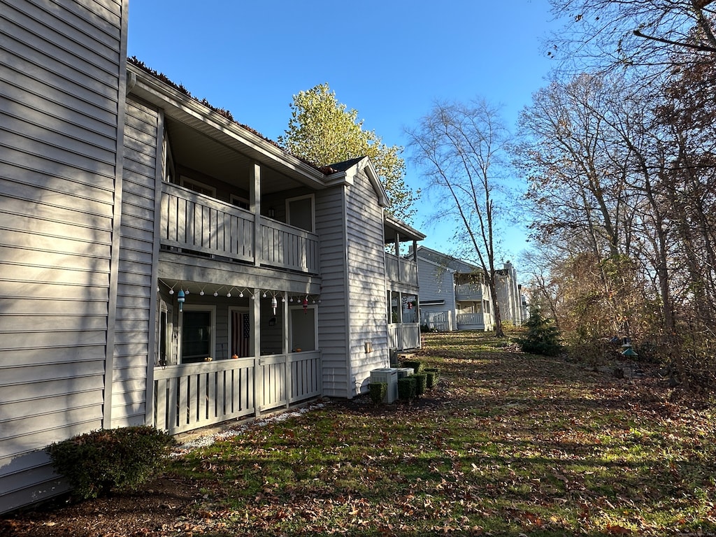 view of side of property with central AC and a balcony