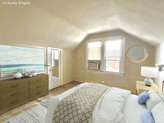 bedroom with cooling unit and vaulted ceiling