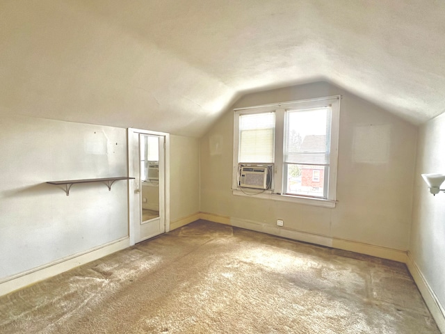 additional living space featuring cooling unit, a textured ceiling, carpet, and vaulted ceiling