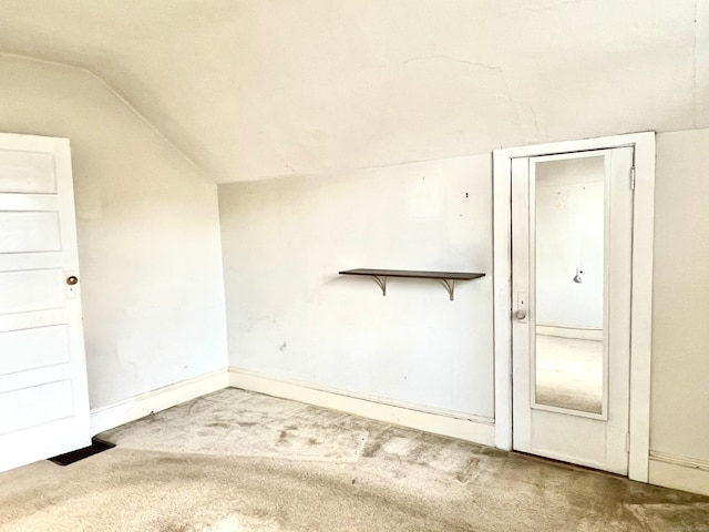 interior space featuring lofted ceiling and carpet flooring