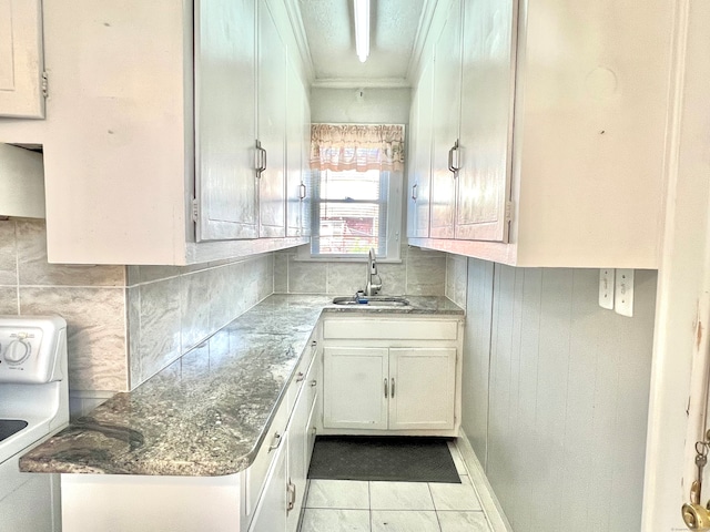 kitchen with white cabinetry, backsplash, and sink