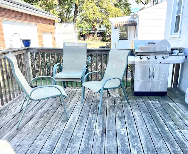 wooden deck featuring a grill