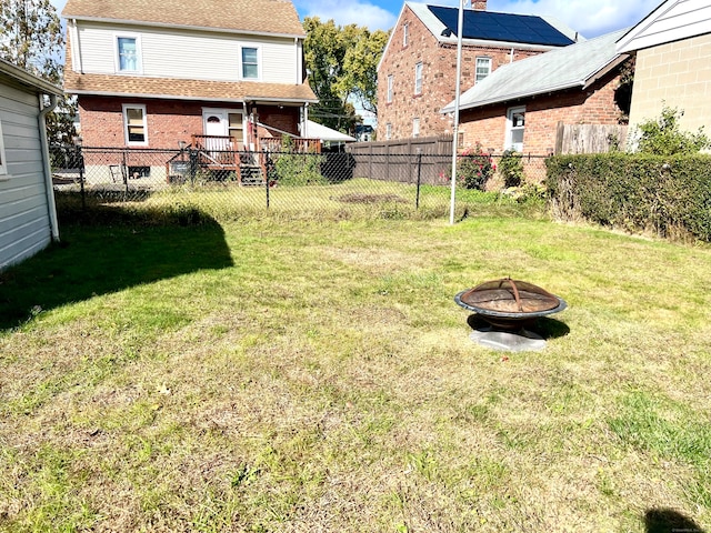 view of yard featuring a wooden deck and a fire pit