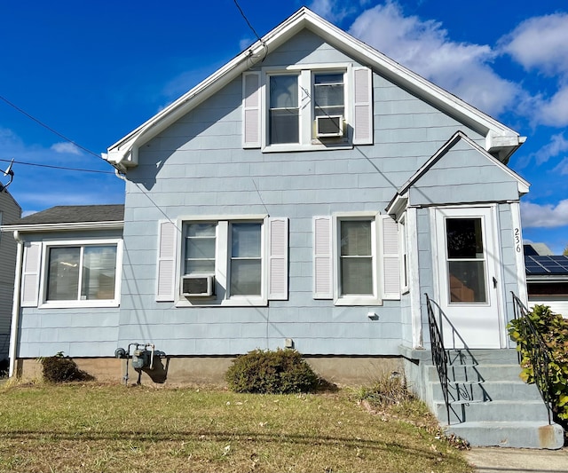 exterior space with cooling unit and a front lawn