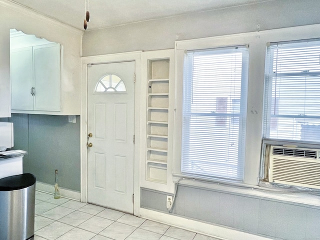 foyer featuring cooling unit and light tile patterned floors