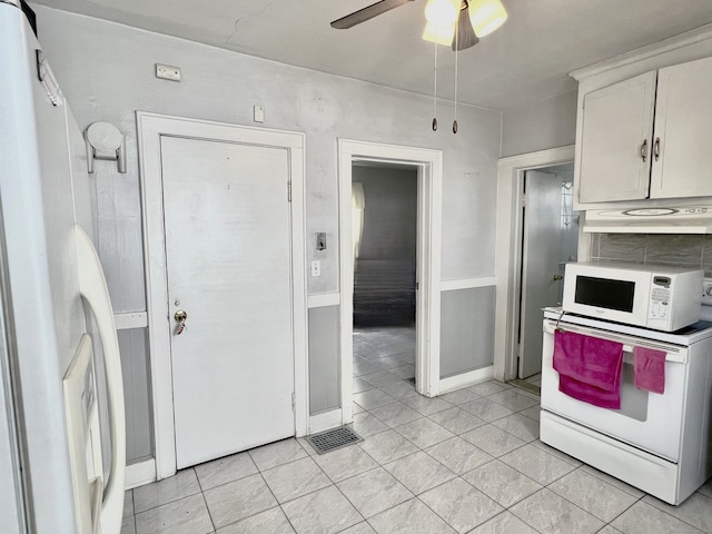 kitchen with white cabinets, light tile patterned flooring, white appliances, and ceiling fan