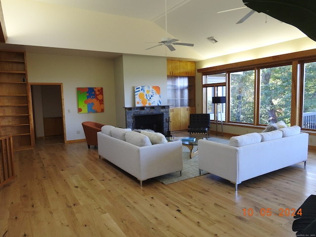 living room with vaulted ceiling, light hardwood / wood-style flooring, and ceiling fan