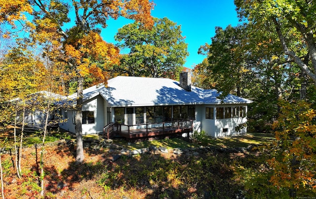 view of front of property with a sunroom and a deck