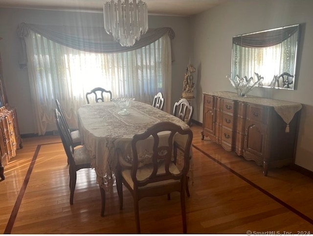 dining space featuring a chandelier and light wood-type flooring