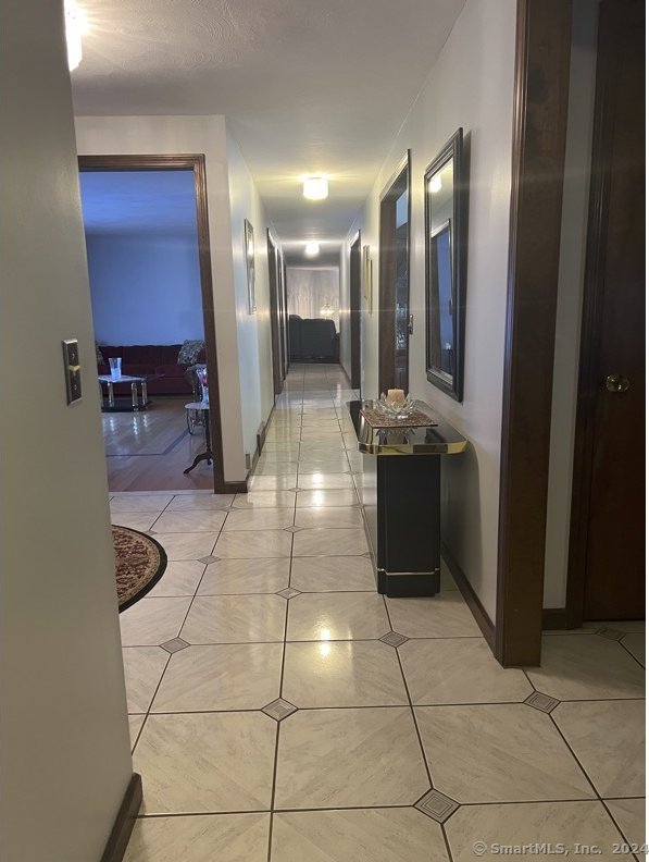 corridor with light tile patterned floors