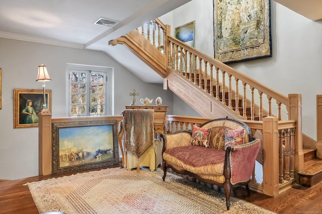 living area with hardwood / wood-style floors and crown molding