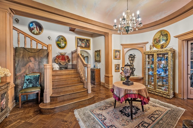 interior space with a notable chandelier, dark parquet floors, and ornate columns