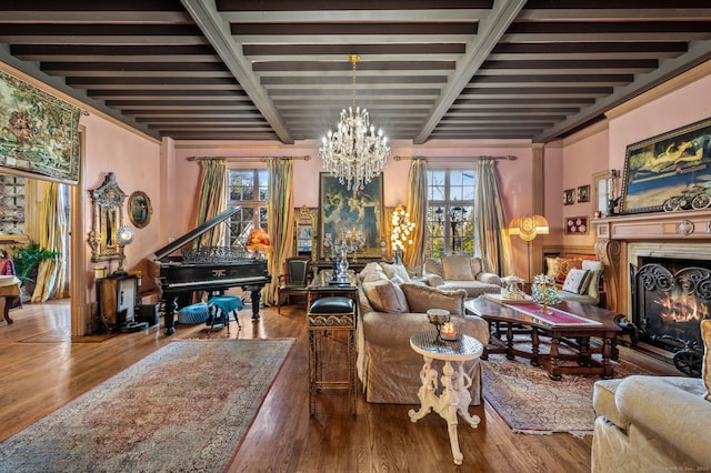 living area featuring beamed ceiling, wood-type flooring, and an inviting chandelier