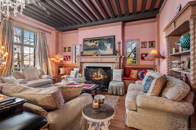 living room with hardwood / wood-style flooring, plenty of natural light, and beamed ceiling