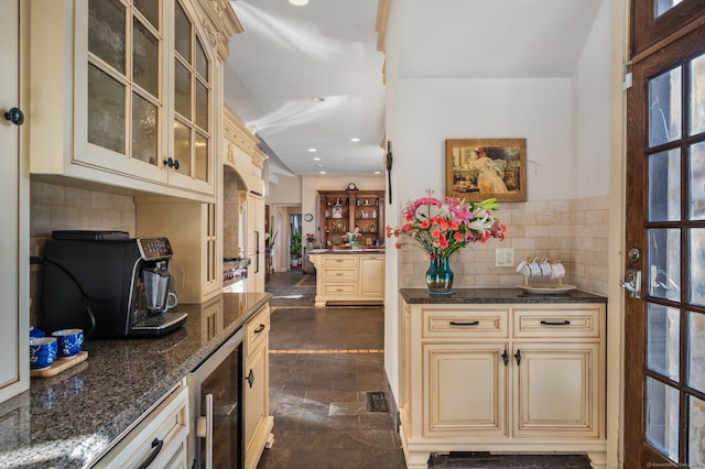 kitchen with cream cabinetry, a wealth of natural light, and beverage cooler