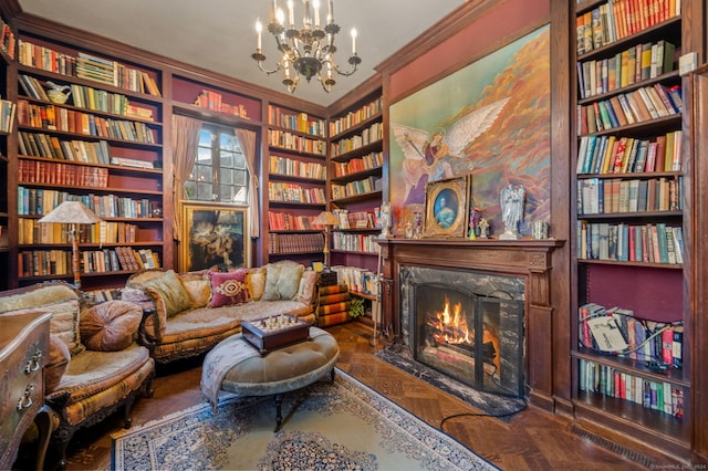 sitting room with an inviting chandelier, parquet floors, crown molding, and a premium fireplace