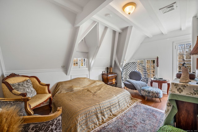 bedroom with hardwood / wood-style floors and lofted ceiling with beams